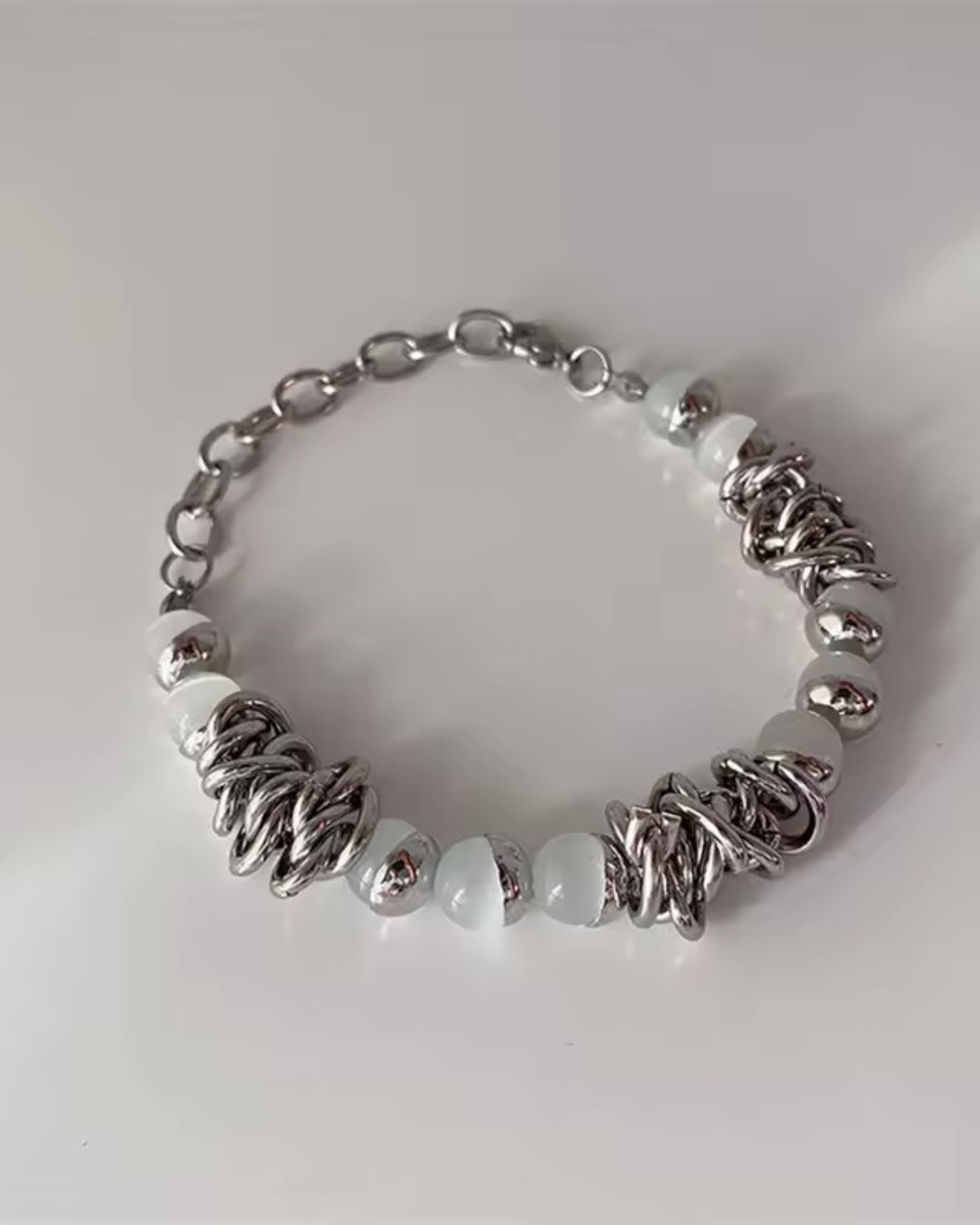 lc-db20fcd3b5fea9dcf7713bc6f62eb72e.jpg White beaded entangled bracelet - Image 1